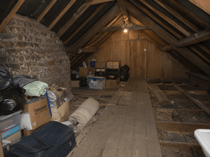 Before loft clearance in Belfast with cluttered attic space